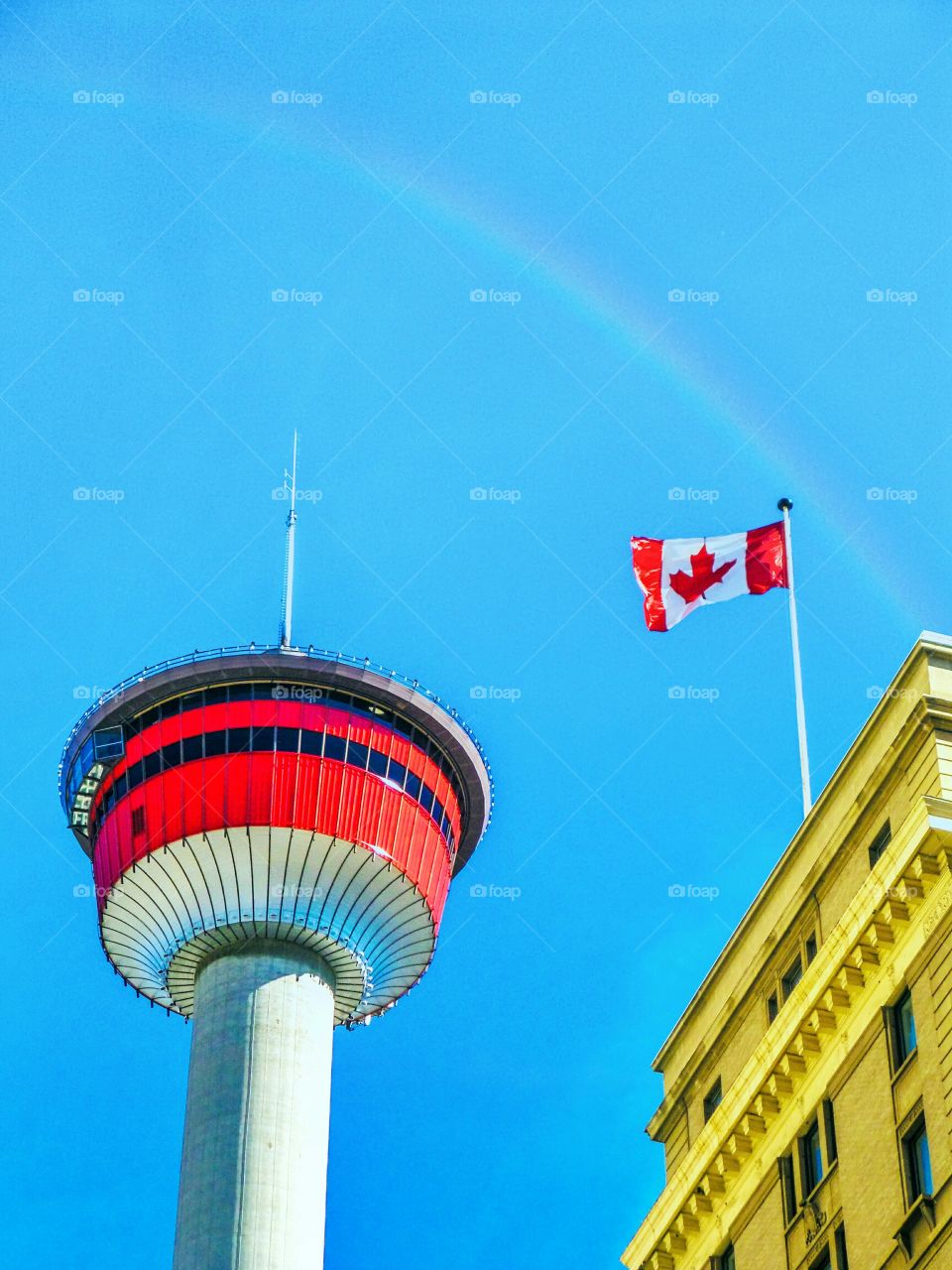 Rainbow above Calgary tower. Last days of summer, a rainbow appeared above the Calgary tower and the flag unfurled