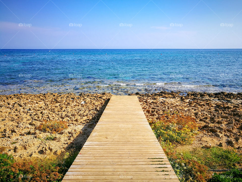 Wooden Jetty beside the Sea. Sea, Beach, Water and Blue Sky.