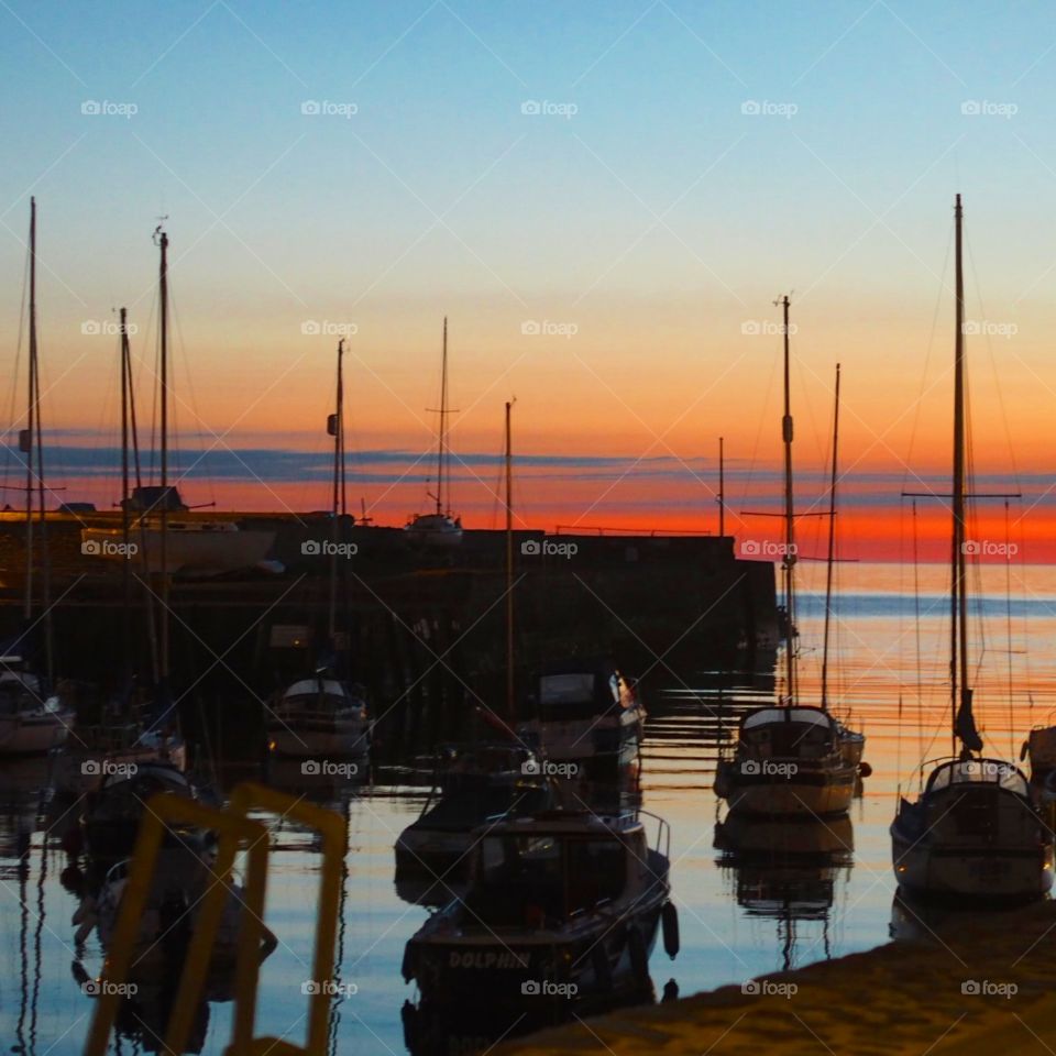 The perfect welsh sunset over Aberaeron Harbour looking out toward the sea