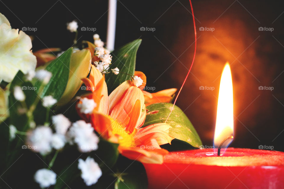 Red candle and flower arrangement