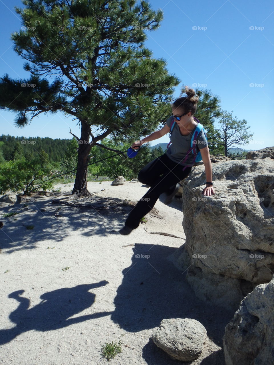 Young woman jumping on rock