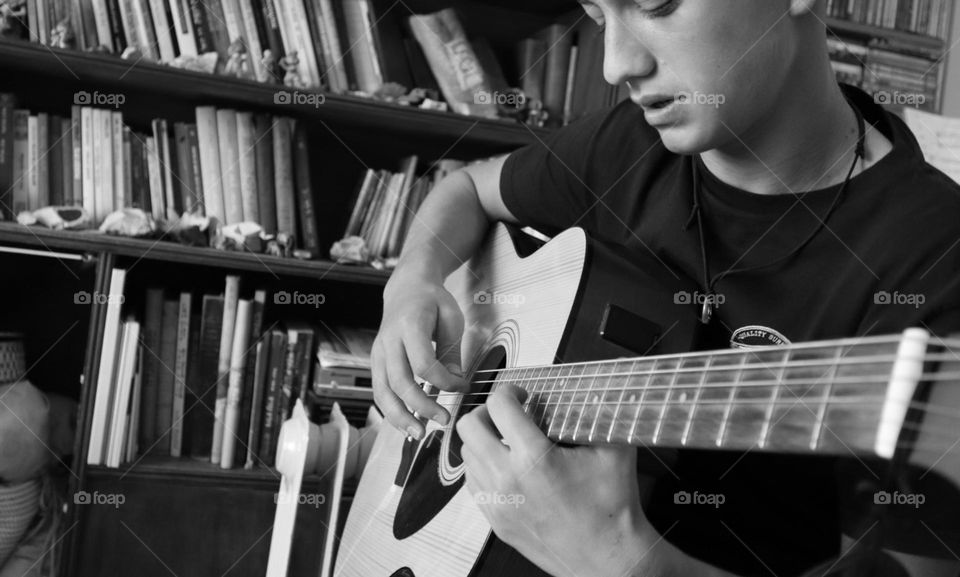 Youth play his guitar