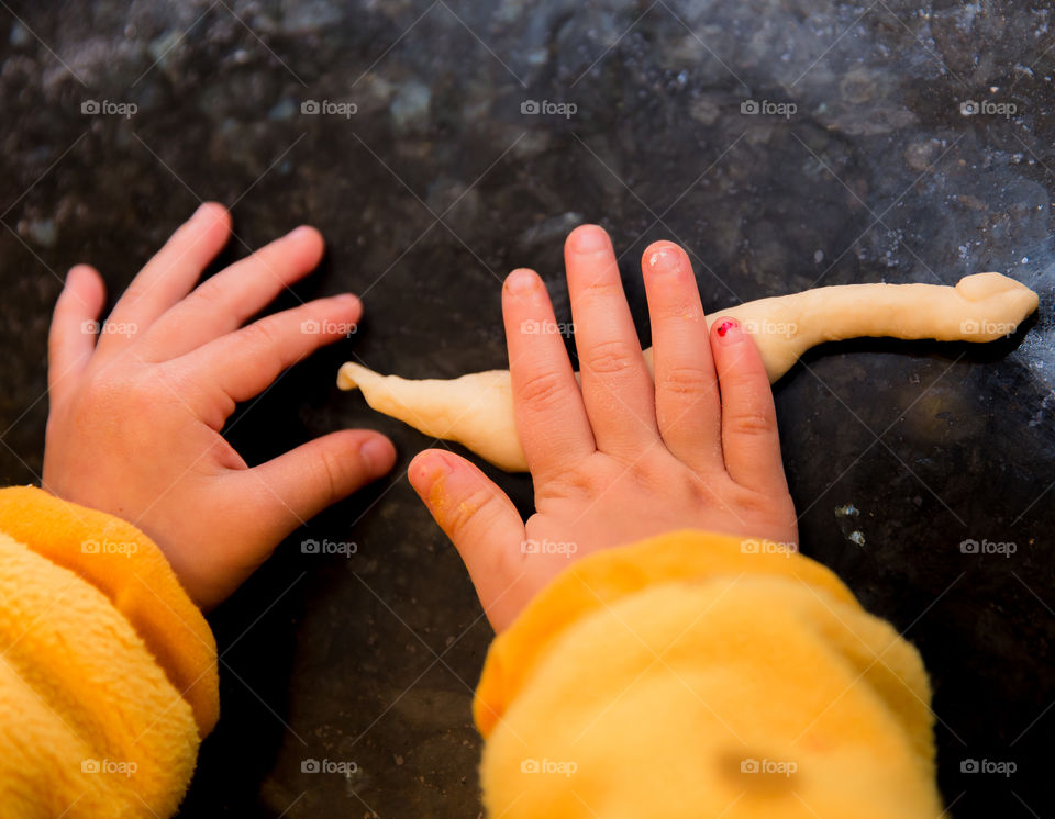 Close-up of a child kneading dough