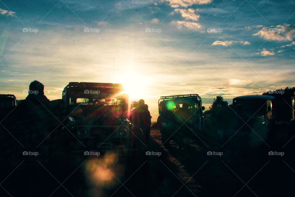 Sunrise that illuminates the car parking area on a hill in the Bromo mountains, East Java.