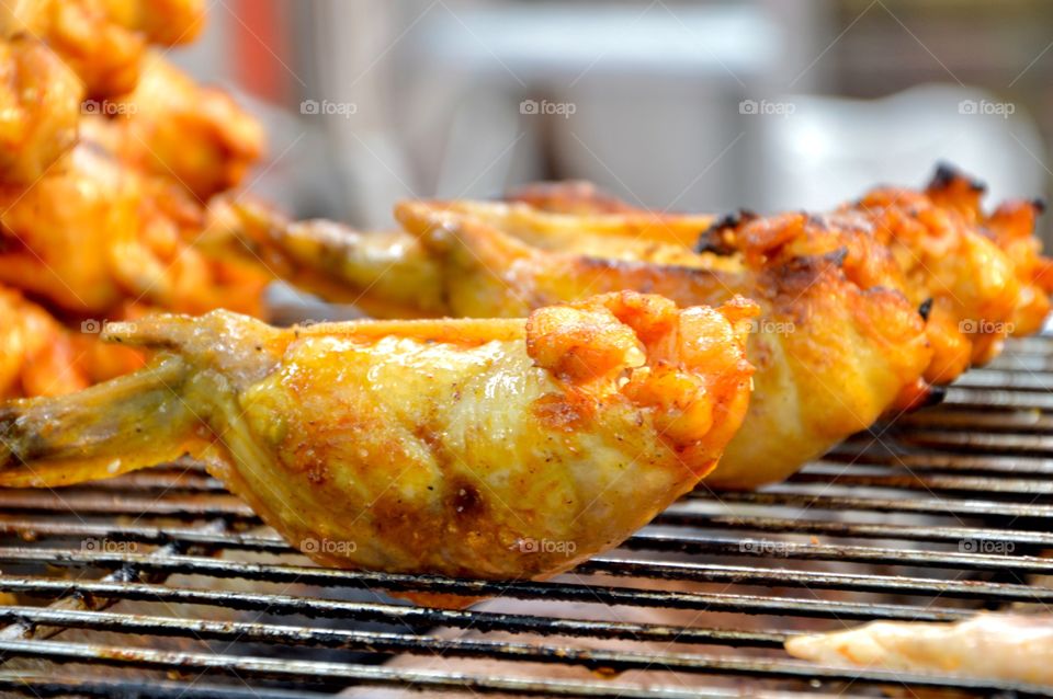 Close-up of chicken wings on barbecue
