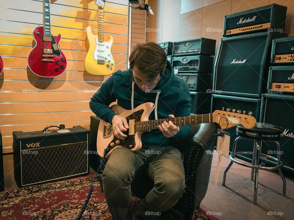 A man plays the guitar