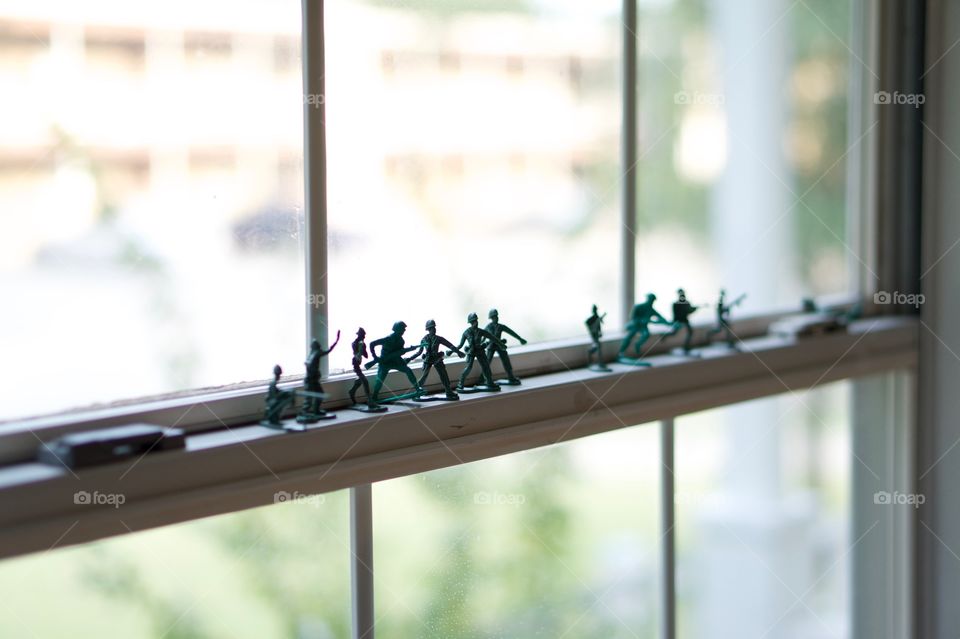 Toy army soldier on window
