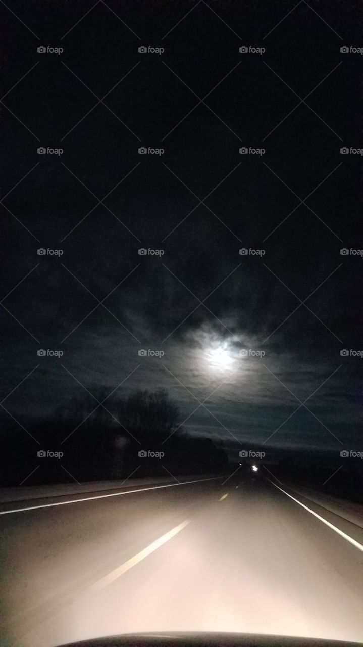 full moon obscured by clouds