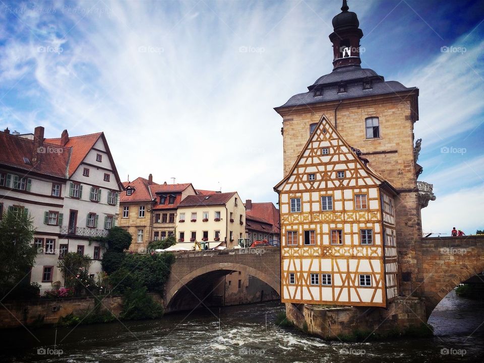 Beautiful olden architecture over a moving river in a small German town.
