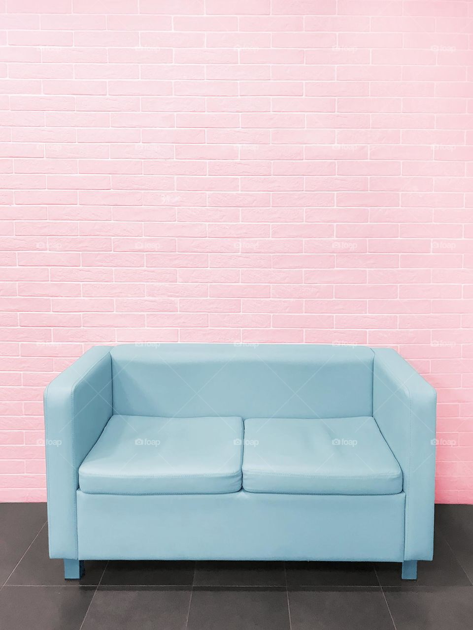 Pink wall blue sofa 