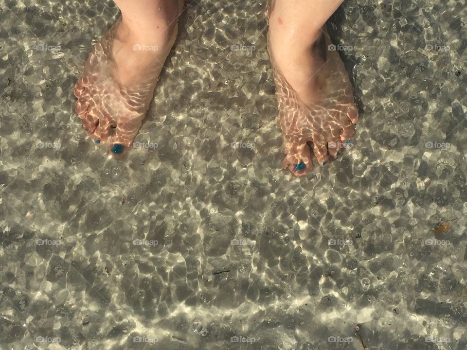 Feet in the ocean