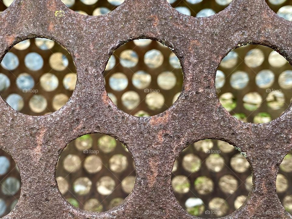 Holes in a metal tube used to sort ore by size