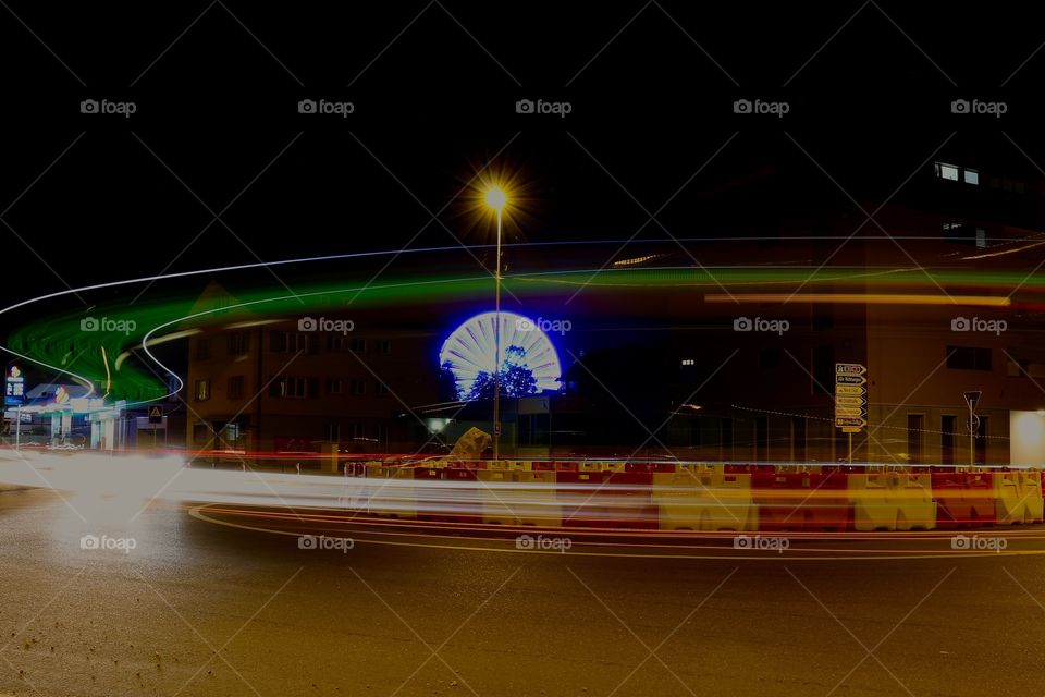 Light trail on street against sky at night