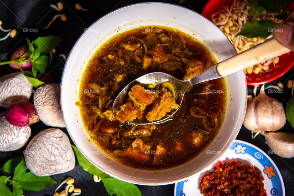 Having a delicious black beef soup