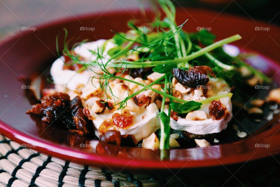 Chèvre cheese salad with apricots , roasted hazelnuts and sunflower sprouts