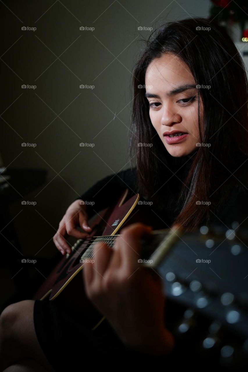 A girl is playing guitar