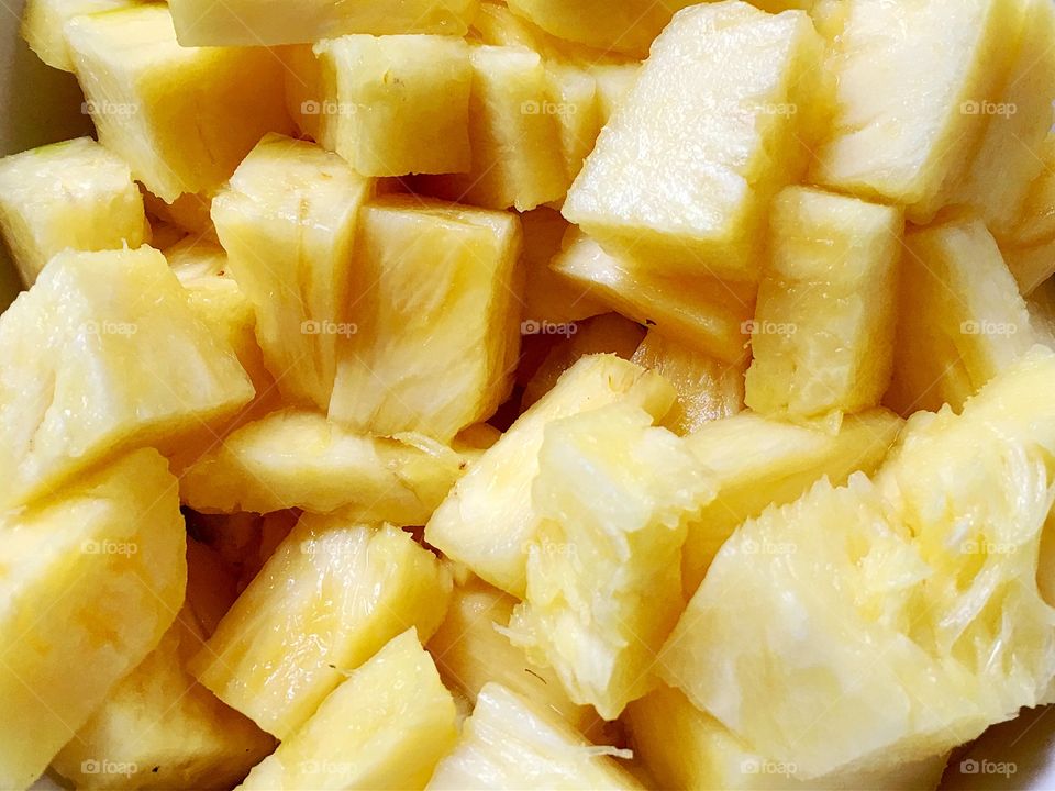 Juicy Pineapple sectioned chunks closeup background image tropical fruit backdrop 