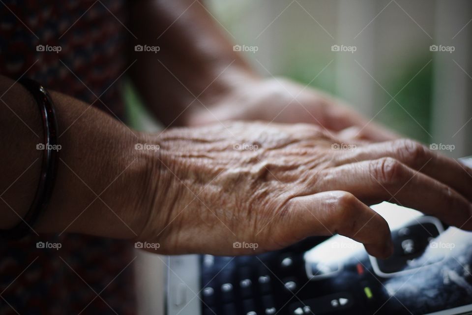 aging hand of hard working woman using tablet and learning technology 