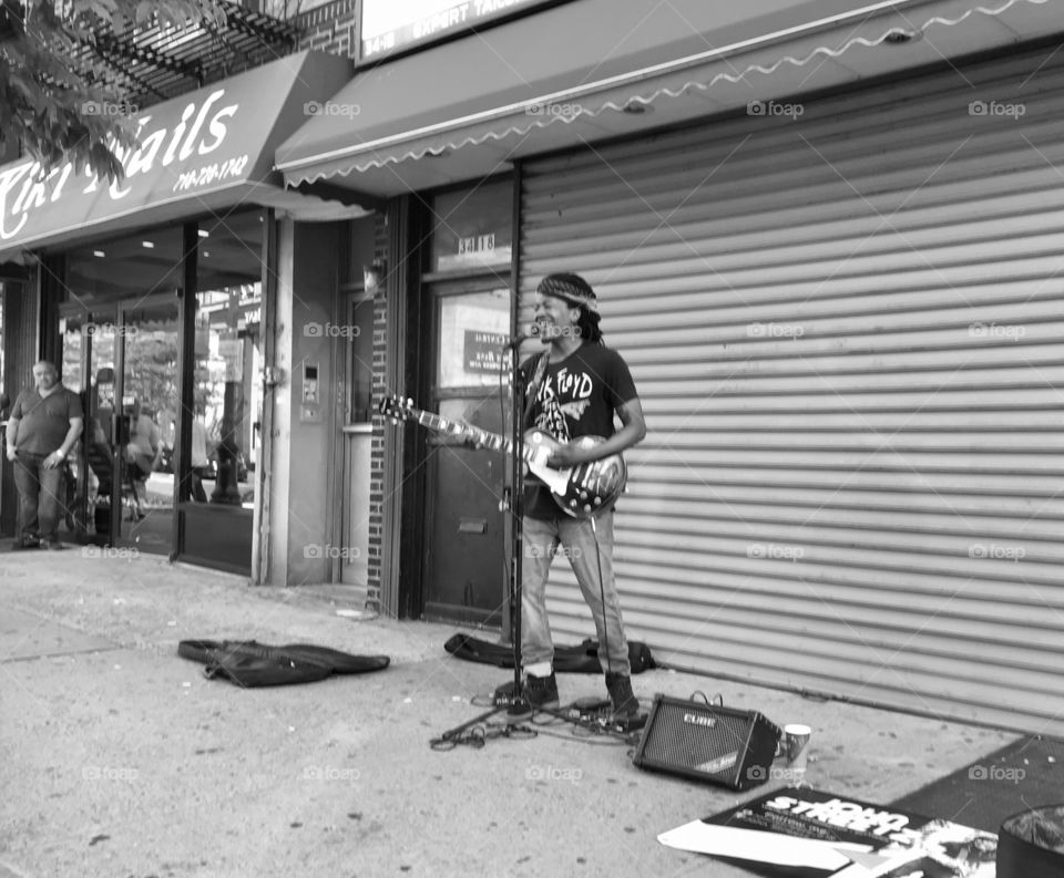 Musician Rocking Electric Guitar on a Busy Queens, New York Street in 2017
