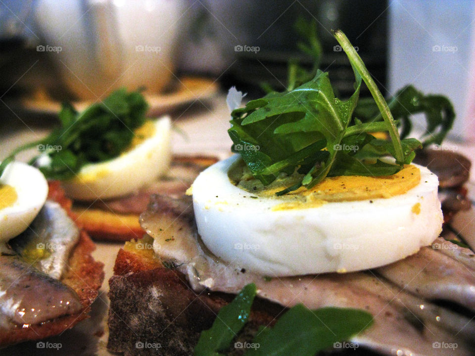 Breakfast. Egg, bread, sardine and rucola.