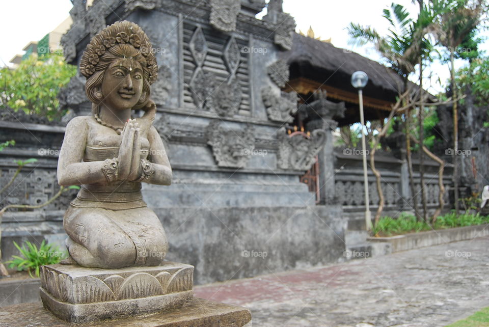 Sculpture of a praying Balinese lady