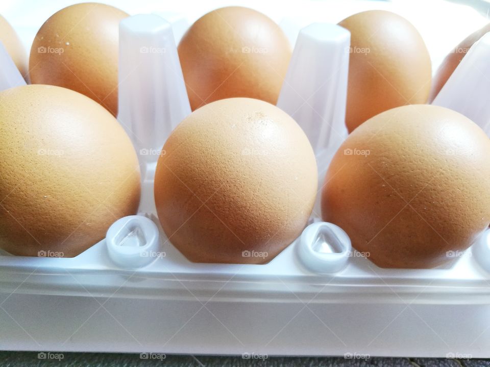 Closeup of eggs in a plastic container