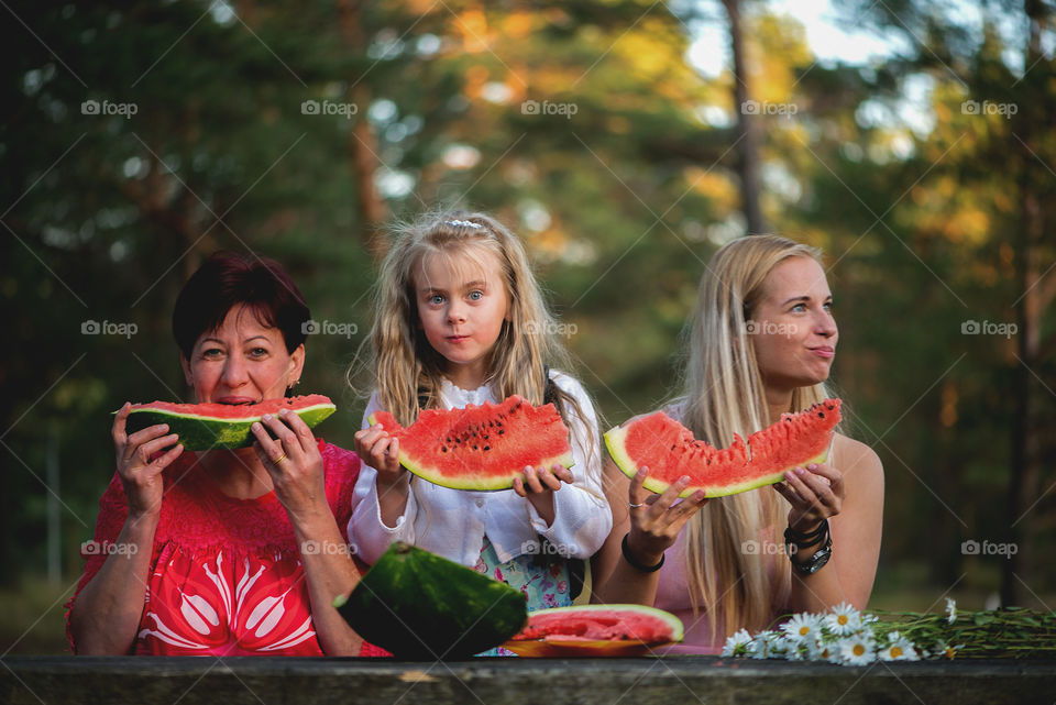 Family eating watermelon