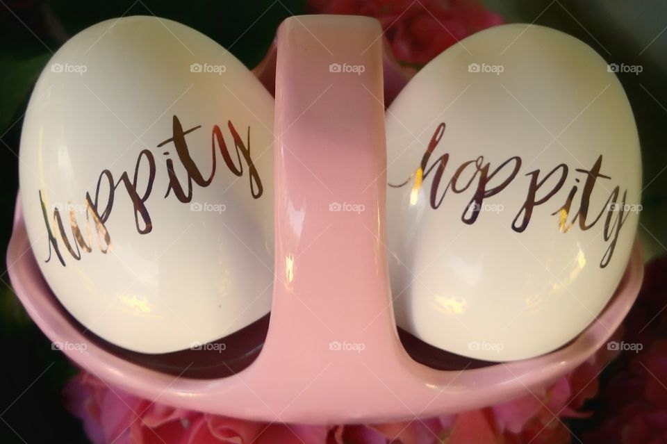 Hippity Hoppity Easter's on its way...two porcelain eggs in a basket with writing on them pink white and gold