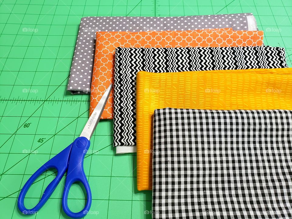 fabric and scissors on a cutting mat