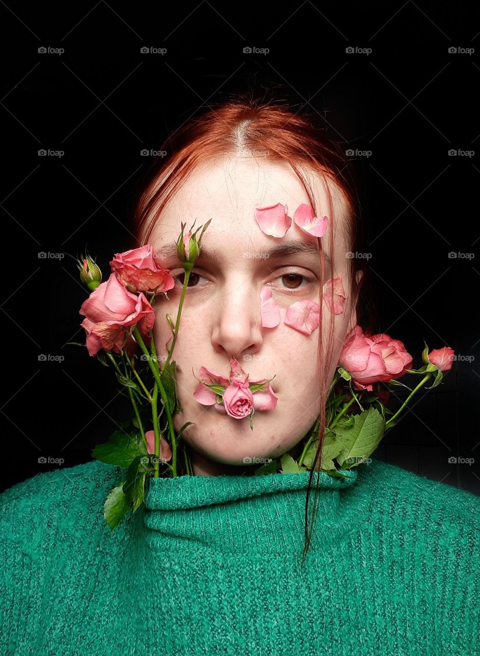 conceptual, floral female portrait with red hair and pink buds, small roses on face