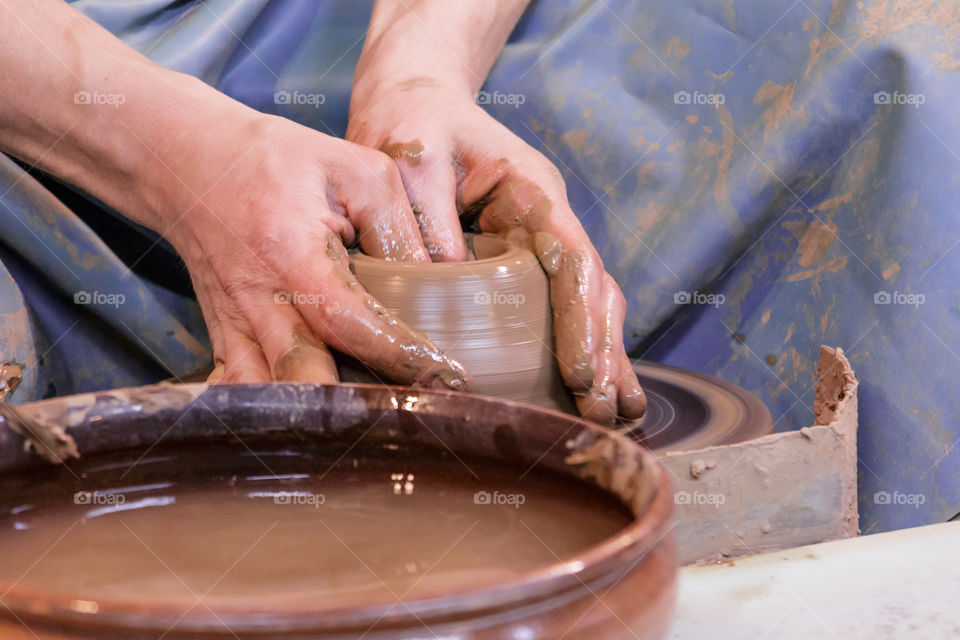 Potter making pitcher`