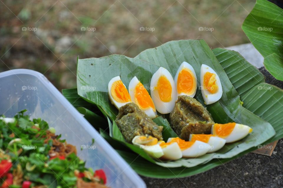 Thai green chili dip with boiled eggs on banana leaf