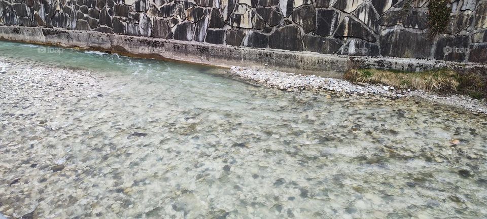 This mountain stream in the vicinity of “Garmisch Partenkirchen” in the Bavarian Alps is ceaselessly bubbling and swirling downstream in the cold winter weather. 2023. Hypnotic Productions