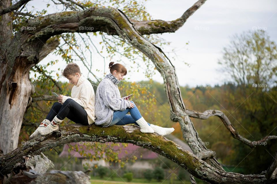 Mother and son using phones