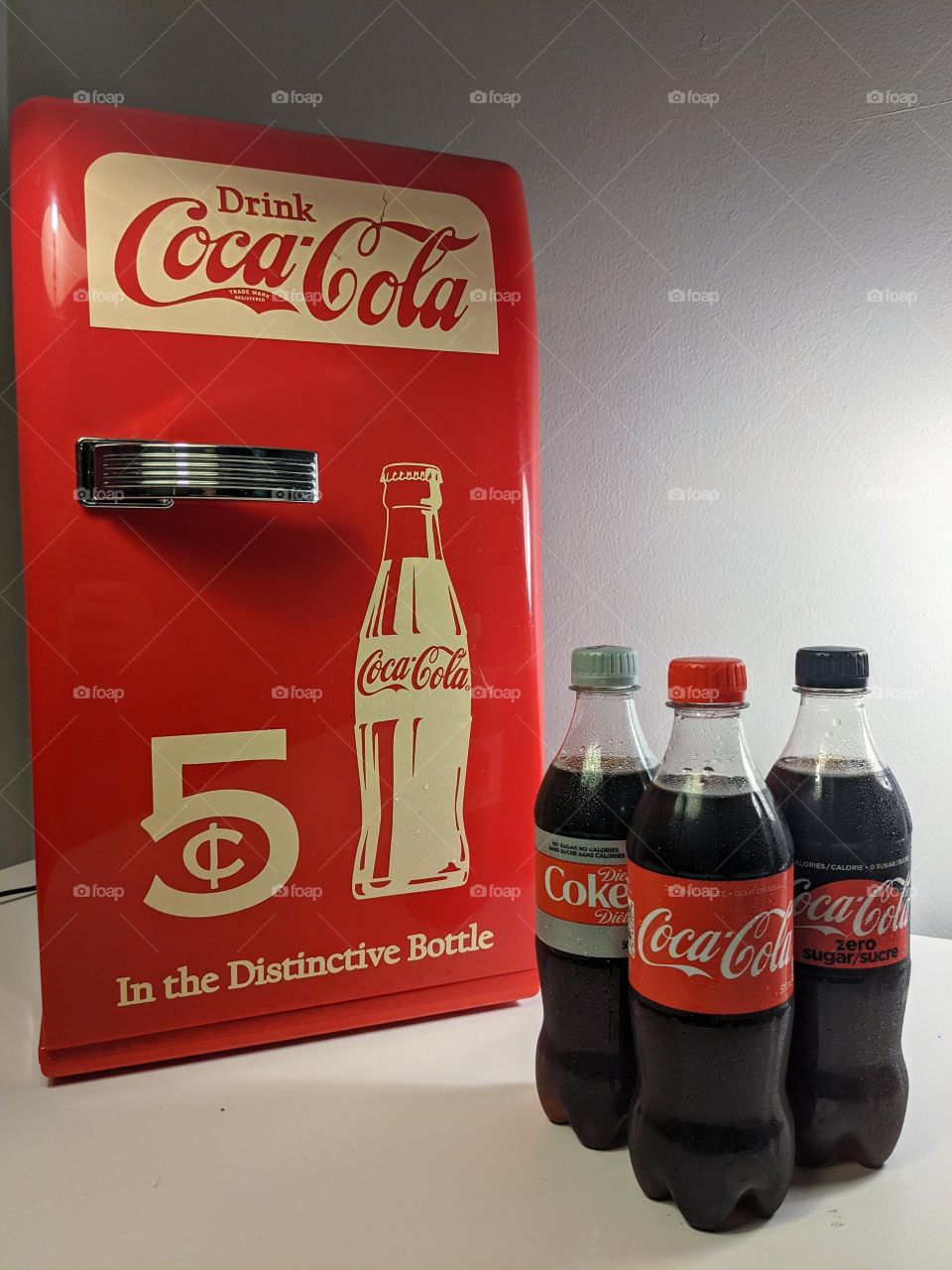 variety of Coca-Cola beverages with mini fridge
