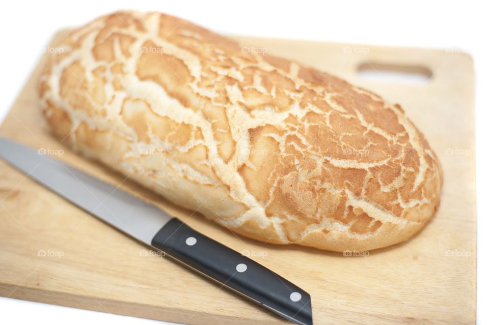 Close view of bread and knife on wood