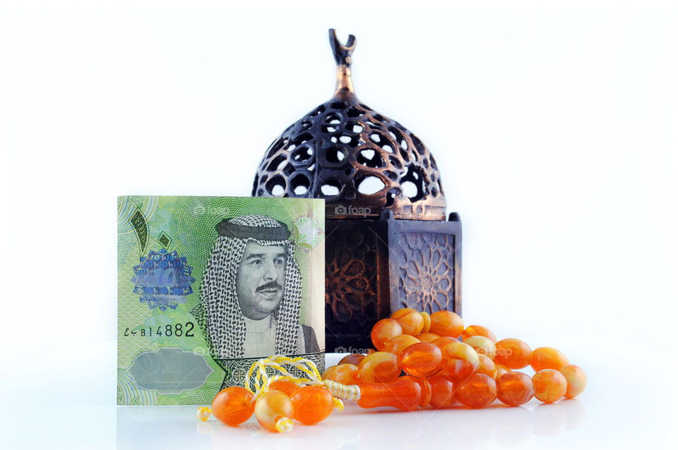 Bahrain currency with rosary isolated background