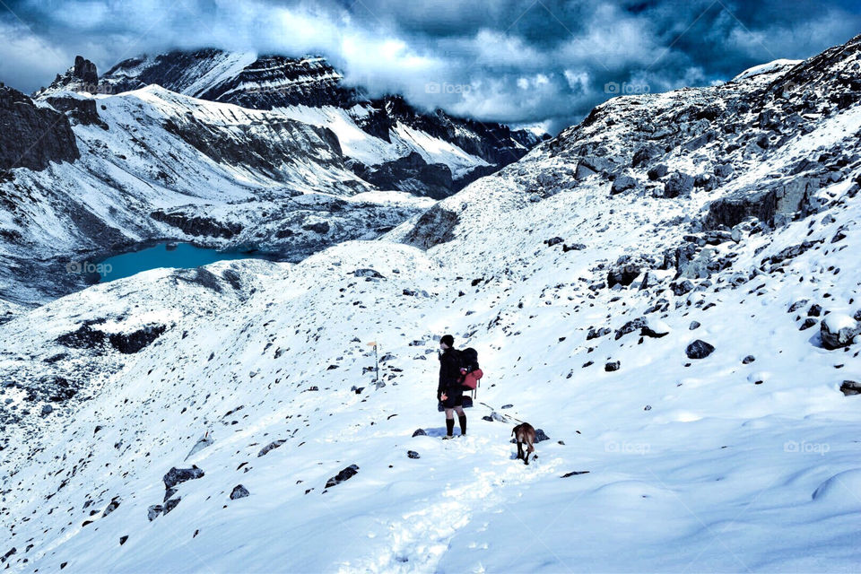 mountain landscape in summer with hiker and dog in front, swiss alps. 