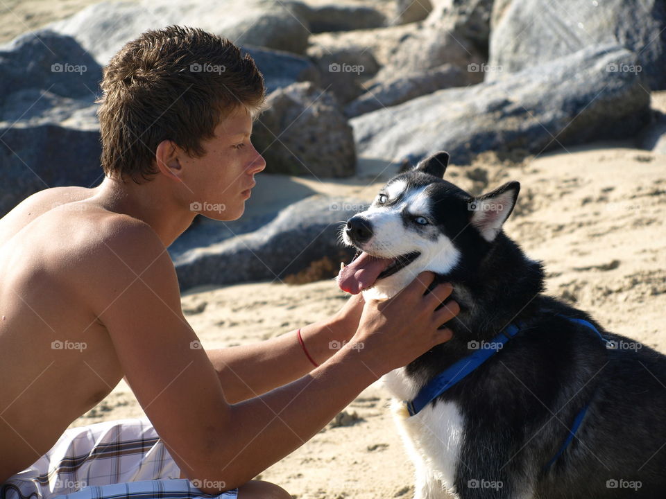 Teenage shirtless boy looking each other