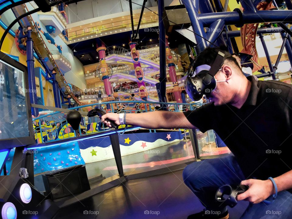 A man intensely enjoying his video game through his goggles