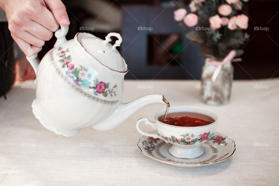 A woman pouring tea