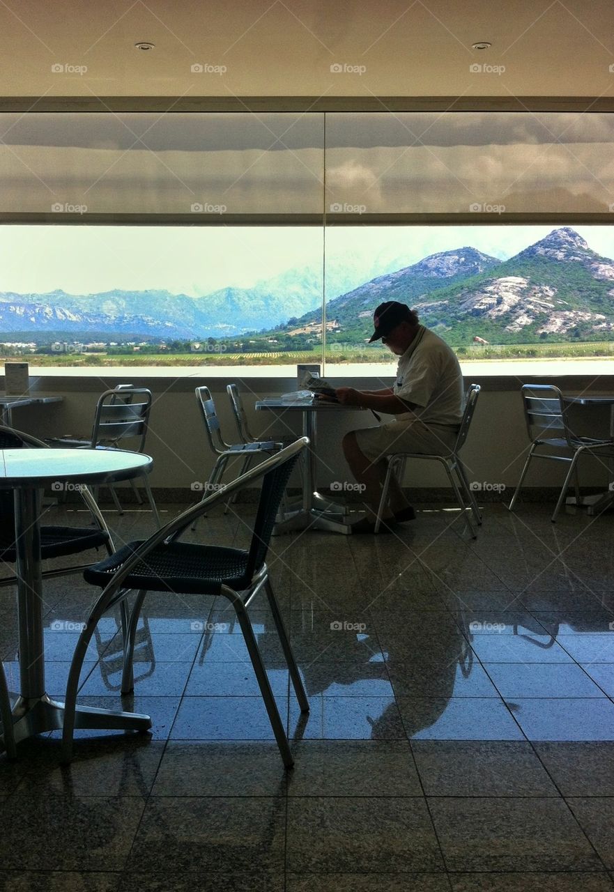 Passenger reading the newspaper in waiting room