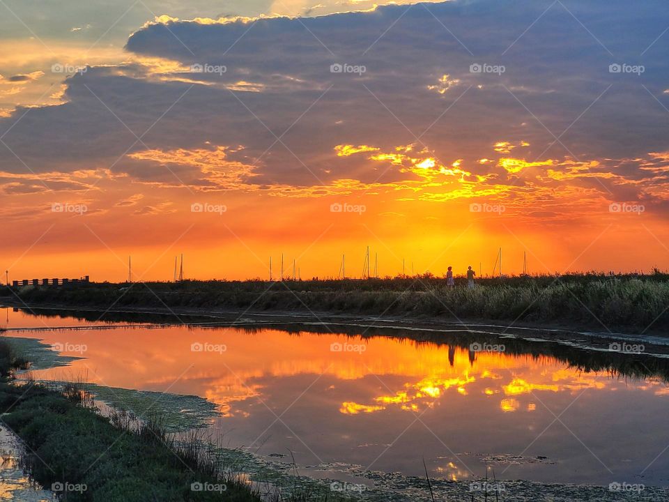 Scenic view of Adriatic sea, coast against orange sunset sky in Slovenia. Summer time. Vacation. Landscape