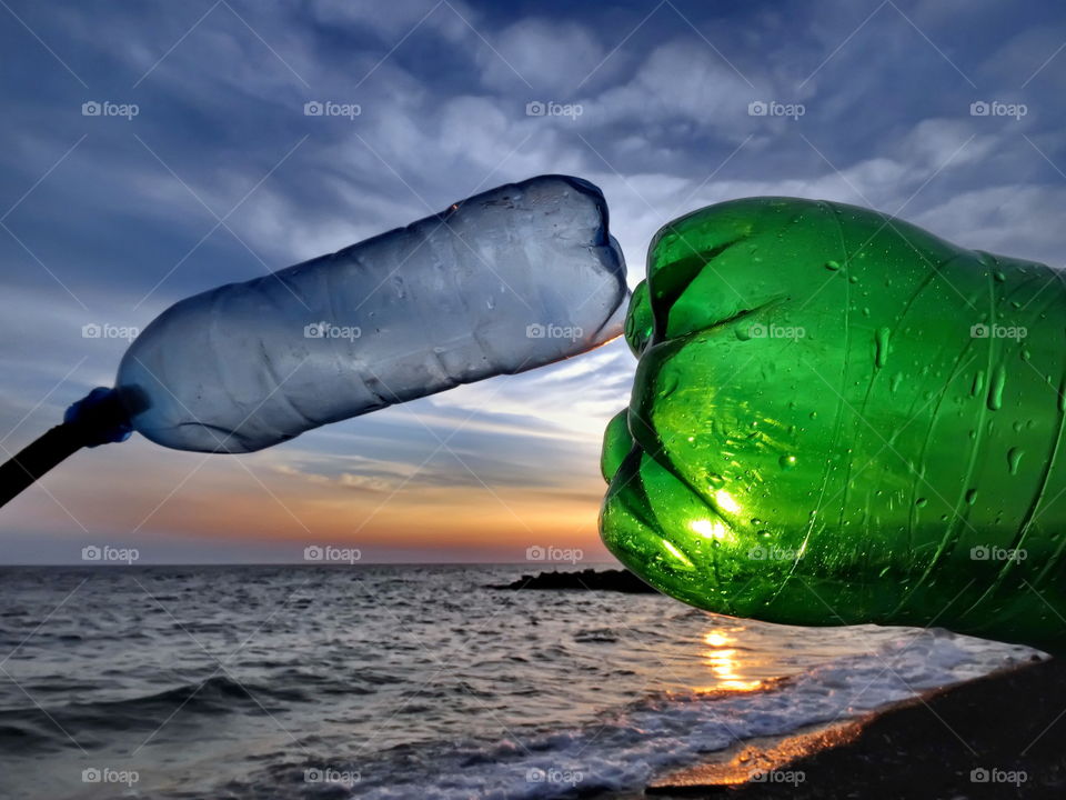 kiss two plastic bottle and sunset