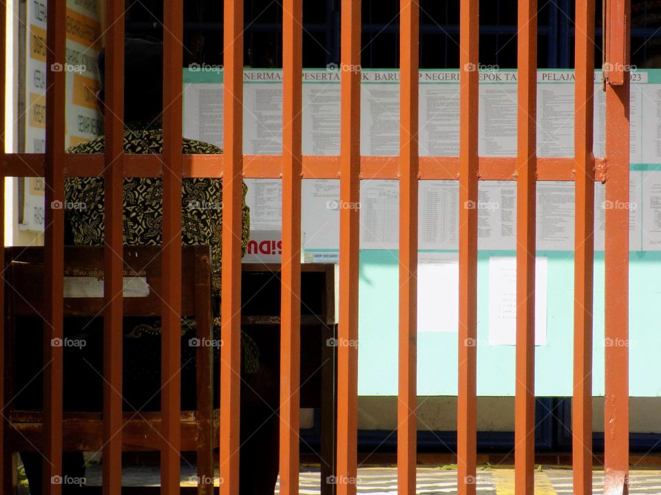 The man behind the school fence