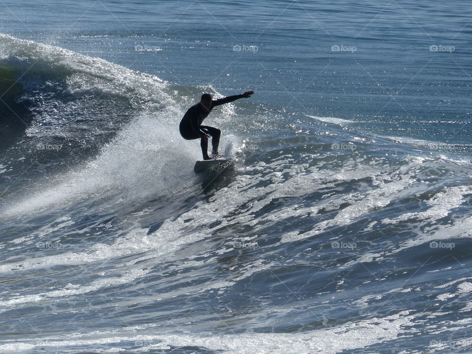 Surfer on edge of a wave 