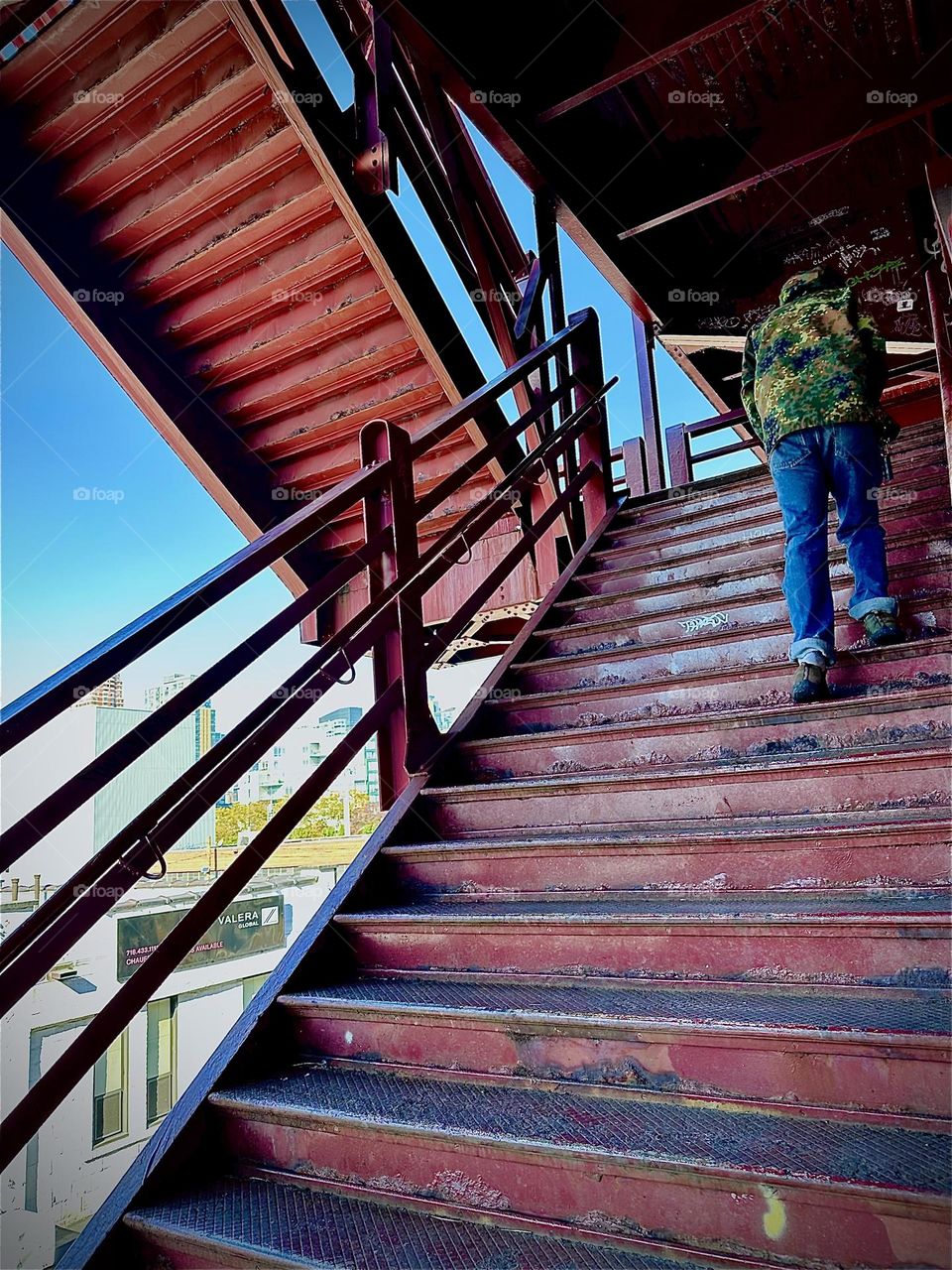 This is the stunning red metal staircase leading up to the pedestrian lane of the “Pulaski Bridge” at “Newtown Creek” in LIC, Queens. It is an applied example of abstract modern art where form meets function splendidly. 2023. Hypnotic Productions