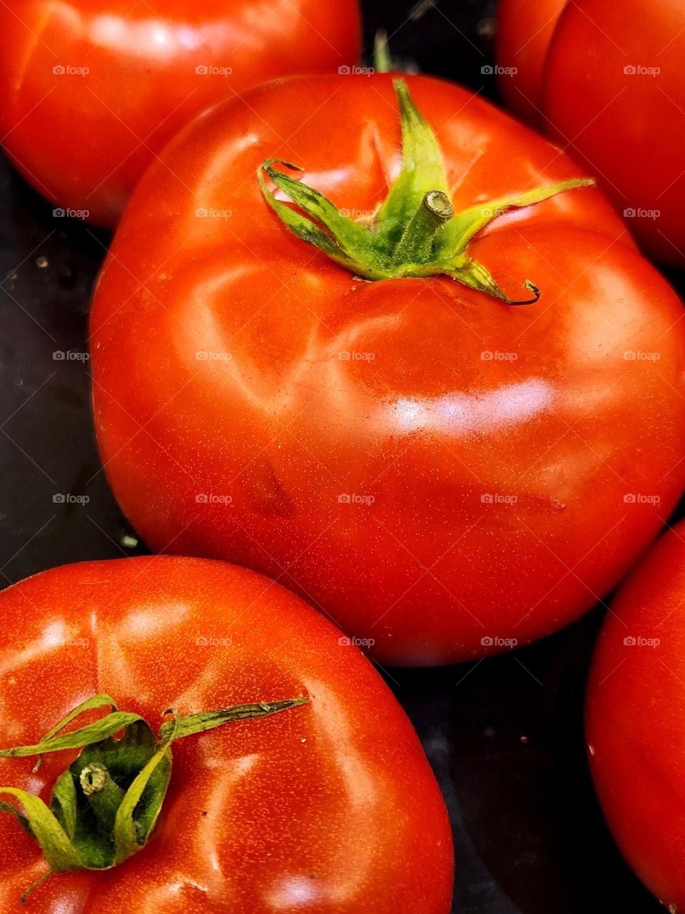 close up view of enticing large bright red beefsteak tomatoes for sale in an Oregon market