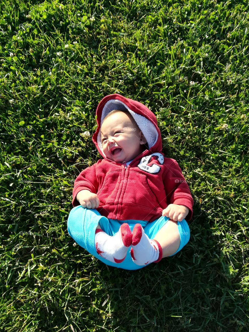 Baby laughing on grass