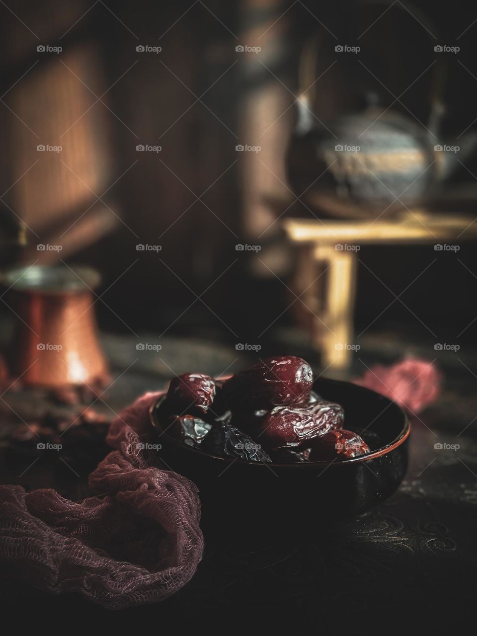 Dates for breaking fast in a black bowl and the sun just set down